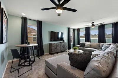 a living room with a couch and a tv at Sea Shore at Solara Resort by Shine Villas #401 villa in Orlando