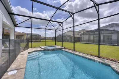 a swimming pool inside of a house with a glass wall at Sea Shore at Solara Resort by Shine Villas #401 villa in Orlando