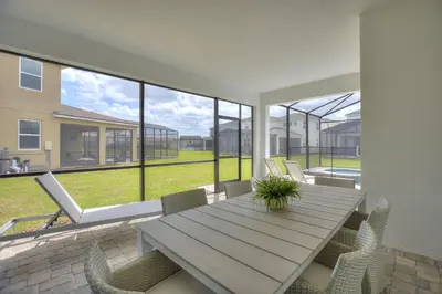 a dining room with a wooden table and chairs at Sea Shore at Solara Resort by Shine Villas #401 villa in Orlando