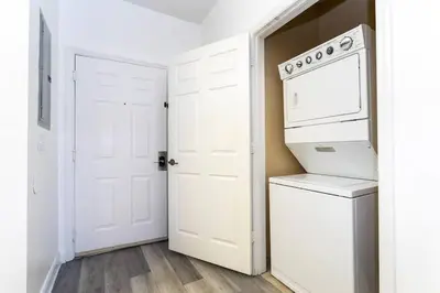 a white laundry room with a washer and dryer at Your Orlando stay 15 min to Disney - DVH01 in Kissimmee
