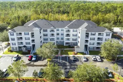 an aerial view of a large apartment building with a parking lot at Your Orlando stay 15 min to Disney - DVH01 in Kissimmee