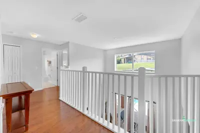 a white room with a staircase with a window at Private Pool, Spa Tub, Themed Rooms, Resort Amenities in Kissimmee