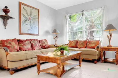 a living room with two couches and a coffee table at Private Pool, Spa Tub, Themed Rooms, Resort Amenities in Kissimmee