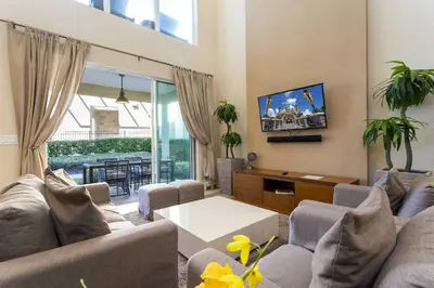 a living room with a couch and a table at Gorgeous 4 Bd Close to Disney @ Magic Village 3114 in Orlando