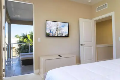 a bedroom with a bed and a sliding glass door at Gorgeous 4 Bd Close to Disney @ Magic Village 3114 in Orlando
