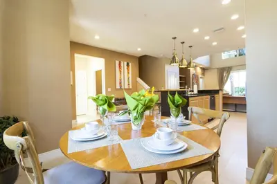 a dining room with a wooden table and chairs at Gorgeous 4 Bd Close to Disney @ Magic Village 3114 in Orlando
