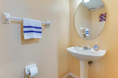 a bathroom with a sink and a mirror at Pool and Hot Tub Home 17 Mi to Epic Universe! in Kissimmee