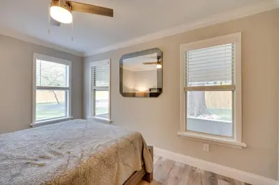 a bedroom with a bed and two windows at Apopka Home with Yard and Grill Near Wekiwa Springs! in Apopka