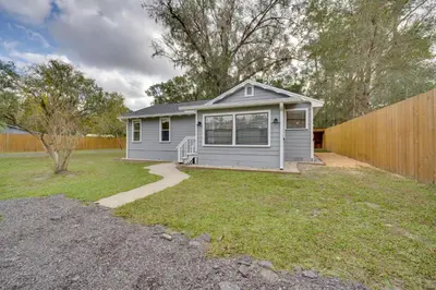 a small house with a fence in a yard at Apopka Home with Yard and Grill Near Wekiwa Springs! in Apopka