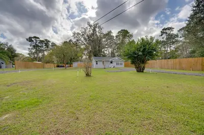 a yard with a fence and a house at Apopka Home with Yard and Grill Near Wekiwa Springs! in Apopka