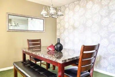 a dining room with a table and chairs and a mirror at Laguna Bay 2 Bedroom Condo Resort Pool 8 Miles to Disney in Kissimmee