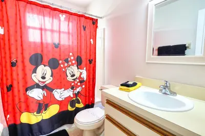 a bathroom with a mickey mouse shower curtain at Laguna Bay 2 Bedroom Condo Resort Pool 8 Miles to Disney in Kissimmee