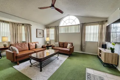 a living room with a couch and a table at Laguna Bay 2 Bedroom Condo Resort Pool 8 Miles to Disney in Kissimmee