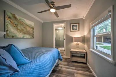 a bedroom with a blue bed and a window at Apopka Getaway with Yard and Covered Patio in Apopka
