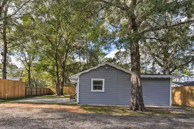 a small house with a tree in the driveway at Apopka Getaway with Yard and Covered Patio in Apopka
