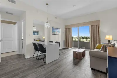 a living room with a kitchen and a living room with a couch at The Point, Lux Apartment 4 min from Universal in Orlando