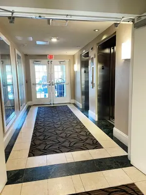an empty hallway in a building with a lobby at The Point, Lux Apartment 4 min from Universal in Orlando
