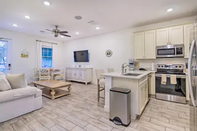 a kitchen and living room with a couch and a table at Tropical Cottage with Hot Tub Near Disney! in Orlando