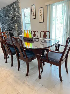 a glass dining room table with chairs and a stone fireplace at Resort Like house, 4 bedrooms, 3 bathrooms in Orlando