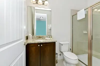 a bathroom with a toilet and a sink and a shower at Vibrant Home Near Disney With Private Pool, Waterpark And Resort Acces At Encore Resorts Reunion - 221Fl in Kissimmee