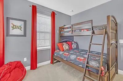 a bedroom with bunk beds and a ladder at 7462 Themed Villa 6BD - Pool Spa-Game room in Orlando