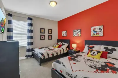 two beds in a bedroom with red walls at 7462 Themed Villa 6BD - Pool Spa-Game room in Orlando