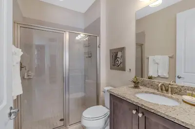 a bathroom with a shower and a toilet and a sink at 7462 Themed Villa 6BD - Pool Spa-Game room in Orlando