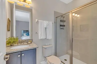 a bathroom with a toilet and a shower and a sink at 7462 Themed Villa 6BD - Pool Spa-Game room in Orlando