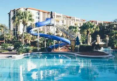 a water slide in a swimming pool in a resort at Amazing Private Villa @ Orang Lake Resort in Orlando