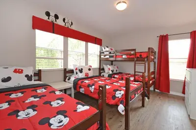 a bedroom with two bunk beds with mickey mouse beds at Summer Sparkle home in Kissimmee