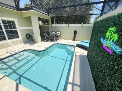 a swimming pool in the backyard of a house at Majestic Retreat townhouse in Kissimmee