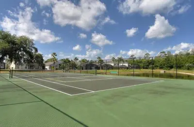 a tennis court with two tennis courts at Ainsdale Haven home in Kissimmee