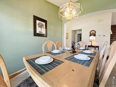 a dining room with a wooden table and chairs at Ainsdale Haven home in Kissimmee