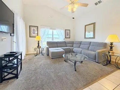 a living room with a couch and a table at Sweet Magnolia home in Orlando