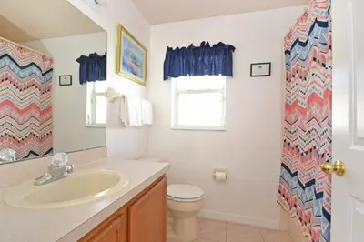 a bathroom with a sink and a toilet at Sweet Magnolia home in Orlando