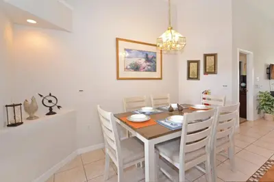 a dining room with a table and chairs at Sweet Magnolia home in Orlando