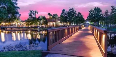 a bridge over a body of water with a sunset at Villa Azul townhouse in Kissimmee