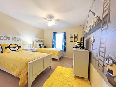 a bedroom with two beds and a childs room with a wall at California Palms condo in Kissimmee