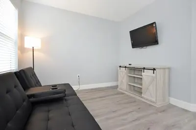 a living room with a couch and a flat screen tv at Hideaway Dream home in Kissimmee