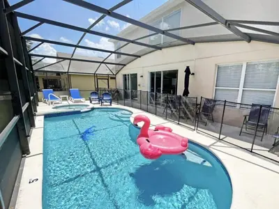 a swimming pool with a pink swan in the water at Hideaway Dream home in Kissimmee