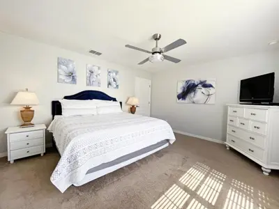 a bedroom with a bed and a ceiling fan at Candy Palm townhouse in Kissimmee