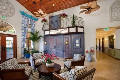 a lobby of a hotel with chairs and a table at Candy Palm townhouse in Kissimmee
