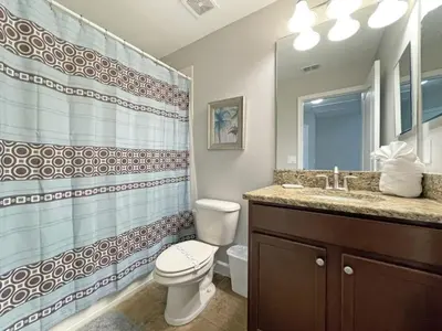 a bathroom with a toilet and a sink at Bamboo Palm home in Kissimmee