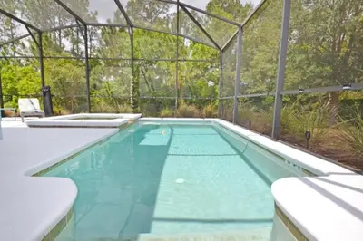 an empty swimming pool with a plastic enclosure at Bamboo Palm home in Kissimmee