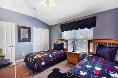 a bedroom with two beds and a window at Veteran Owned 3bdr/3 bath Townhouse w/WiFi 3mi to Disney - Winter/Spring Specials in Kissimmee