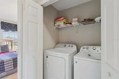 a laundry room with two washing machines and a window at Veteran Owned 3bdr/3 bath Townhouse w/WiFi 3mi to Disney - Winter/Spring Specials in Kissimmee