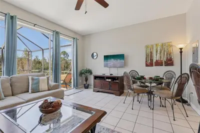 a living room with a couch and a table at Veteran Owned 3bdr/3 bath Townhouse w/WiFi 3mi to Disney - Winter/Spring Specials in Kissimmee