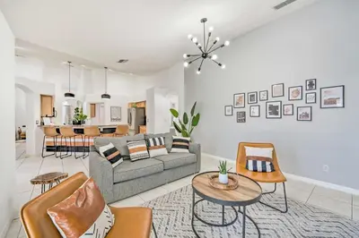 a living room with a couch and a table at Clermont Vacation Rental with Pool 11 Mi to Disney in Orlando