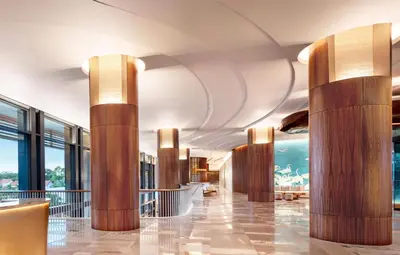 a lobby of a hotel with wooden columns at Conrad Orlando in Orlando