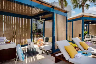 an outdoor patio with white chairs and a table at Conrad Orlando in Orlando